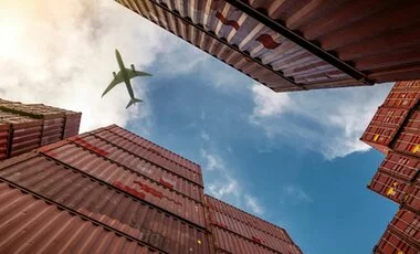 Airplane Flying Above Containers